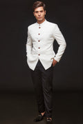 Man wearing a white Jodhpuri jacket with dark buttons and black pants | By Aditya Bhardwaj